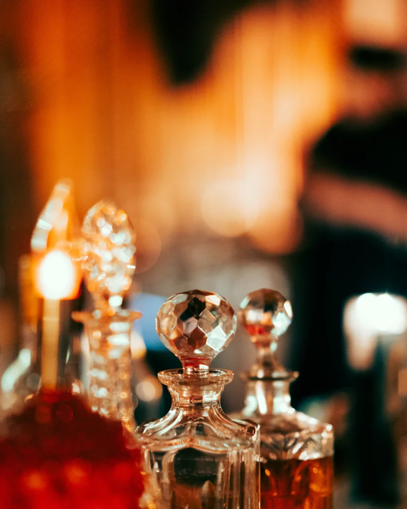 Crystal attar bottles filled with amber oils in warm light — Abrar Attar House story